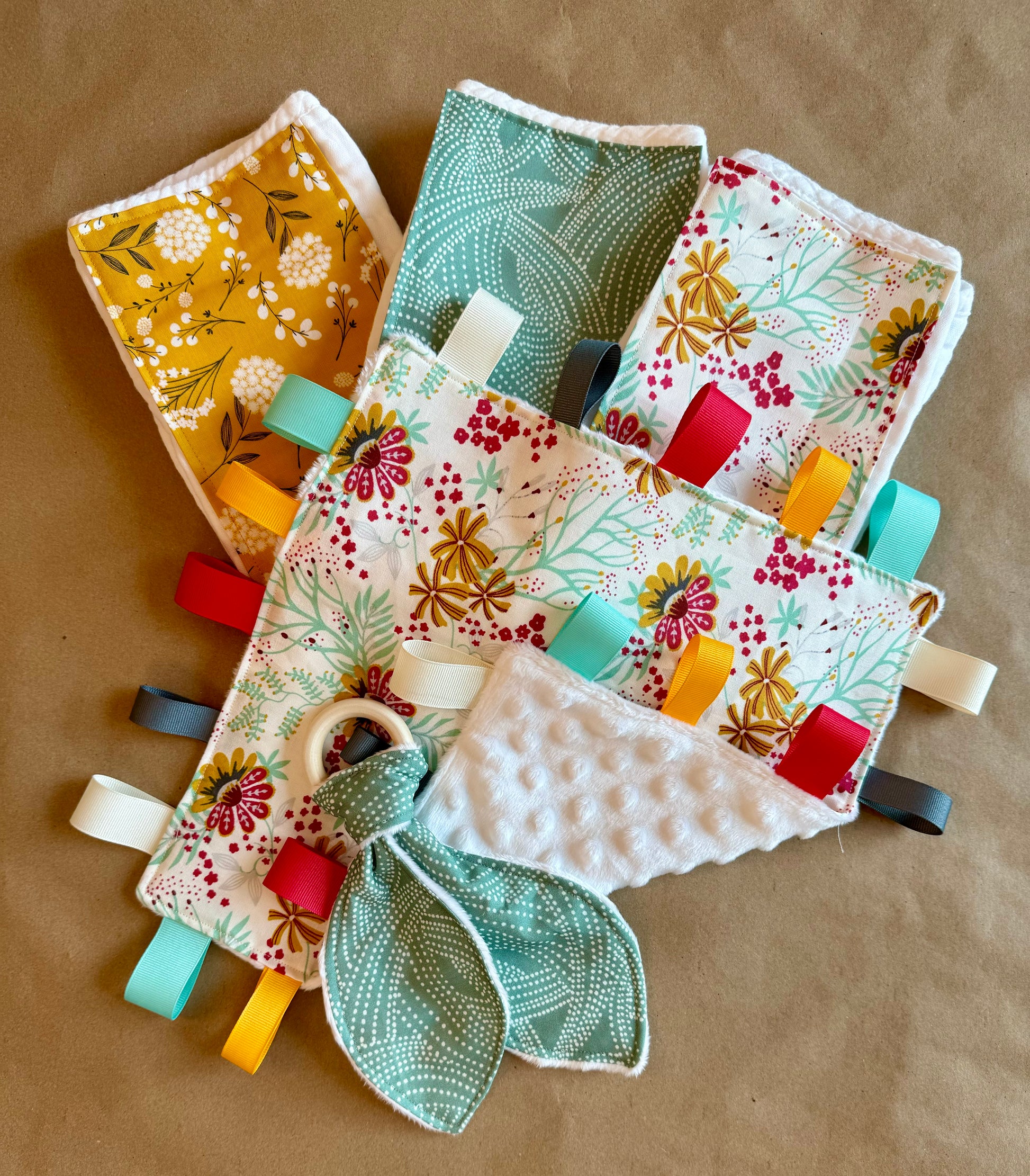 infant newborn baby girl flowers wildflowers floral sage polka dots mustard floral burp cloths sensory tag blanket teether teething ring wood nursing cotton diaper minki minky grosgrain ribbon